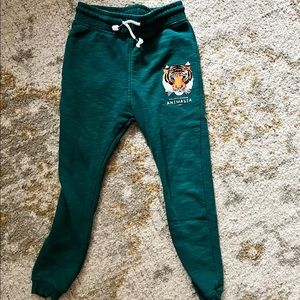 Green boys joggers with tiger logo.